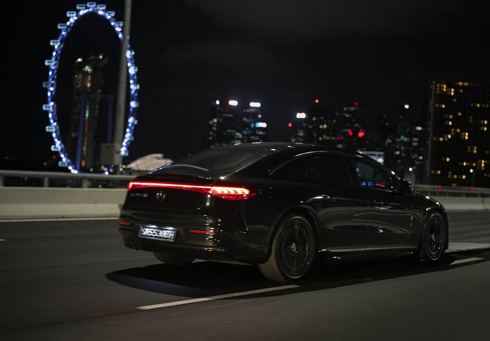 Luxury sedan driving through Singapore at night